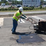 Applying crack fill around asphalt patch in Falls Church